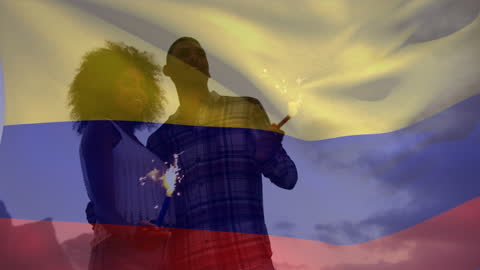 Friends Celebrating with Sparklers Overlayed by Colombian Flag