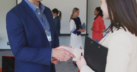Colleague Handshake at Business Conference in Office