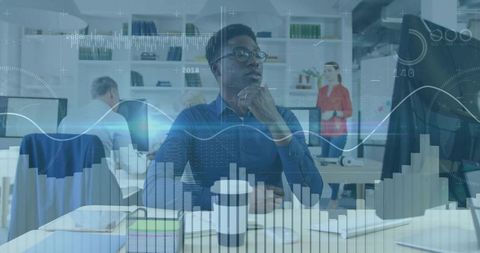 Data analyst reviewing graphs in modern workspace