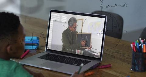 Child attending online math lesson with tutor teaching geometry on laptop