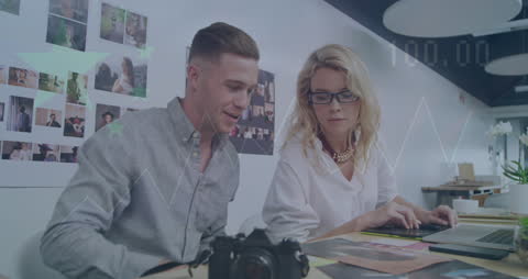 Business Meeting Analyzing Market Data with Camera in Office