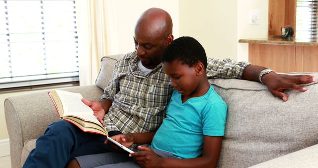 Father and Son Bonding at Home through Reading and Technology - Download Free Stock Images Pikwizard.com