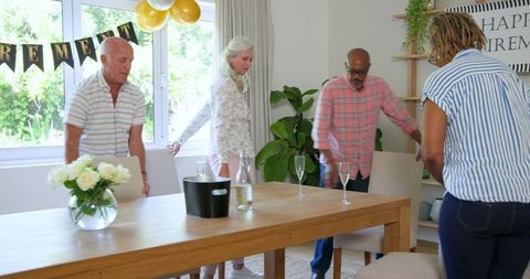 Senior Friends Celebrating Retirement with Champagne Gathering