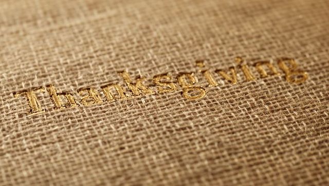 Rustic gold Thanksgiving embroidery on burlap fabric macro texture for holiday design