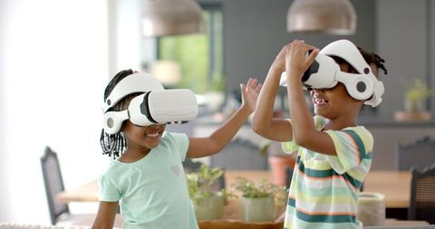 Happy Siblings Exploring Virtual Reality at Home Together