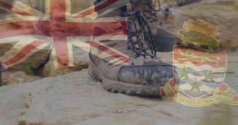 Hiking Boots on Rocky Terrain Under Cayman Flag