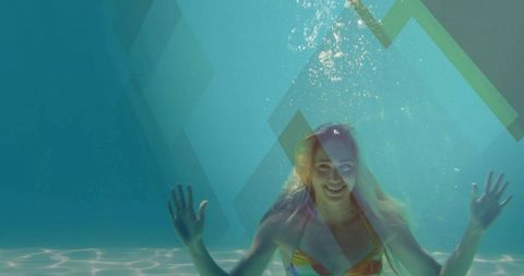 Smiling woman floating underwater in colorful bikini with sunlit caustics, geometric overlays