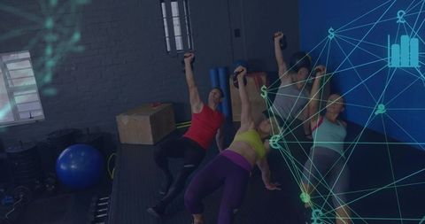 Group Holding Kettlebells Doing Glute-Bridge Exercises on Rubber Floor in Functional Training Studio