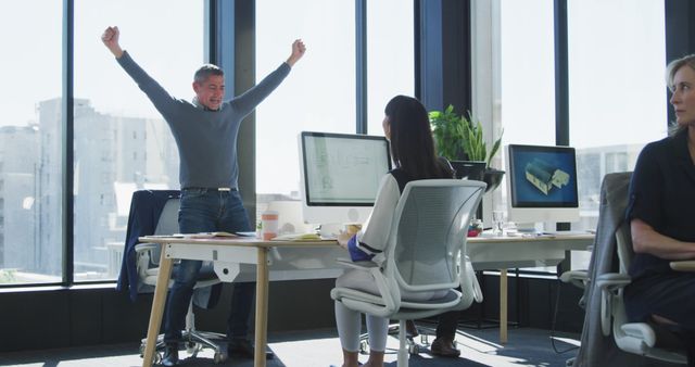 Excited Male Colleague Celebrating Success in Modern Office - Download Free Stock Images Pikwizard.com