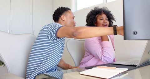 Couple Collaborating on Laptop in Home Office