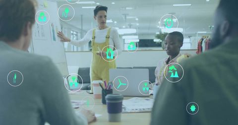Diverse Team in Office Meeting, Ecology Icons Overlay