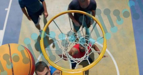 Overhead view of players jostling for rebound under outdoor basketball hoop in sunlight