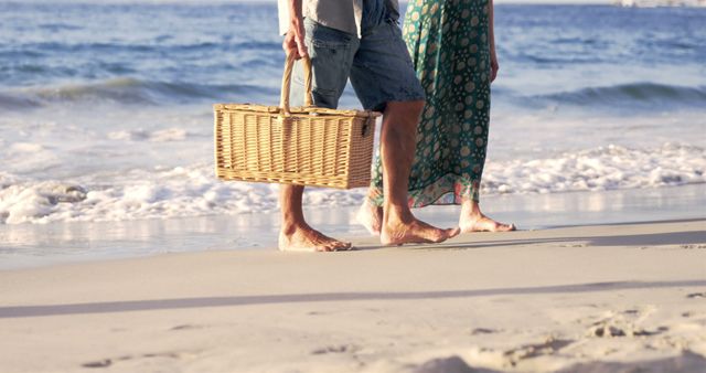Couple Walking on Beach Holding Picnic Basket During Sunset - Download Free Stock Images Pikwizard.com