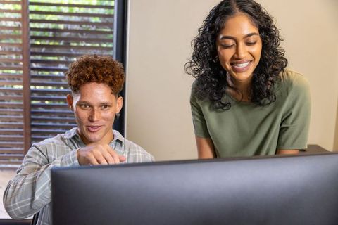 Diverse coworkers collaborating at modern office workspace