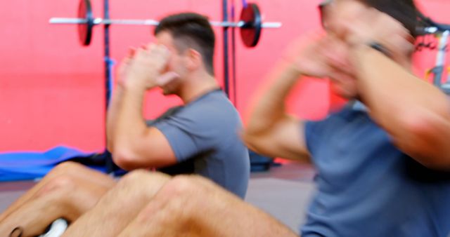 Two young men performing sit-ups in gym - Download Free Stock Images Pikwizard.com