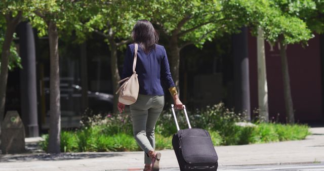 Businesswoman Wheeling Suitcase Outdoors in City - Download Free Stock Images Pikwizard.com