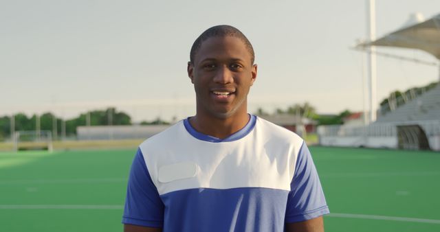 Smiling Athlete in Sports Jersey on Green Field Outdoors - Download Free Stock Images Pikwizard.com