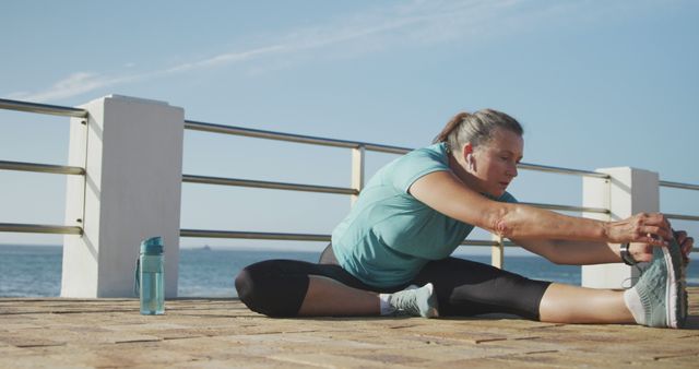 Older Woman Stretching on Seaside Promenade Maintaining Flexibility - Download Free Stock Images Pikwizard.com