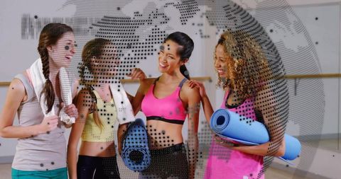 Smiling women holding yoga mats and towels, chatting in fitness studio with dotted globe overlay