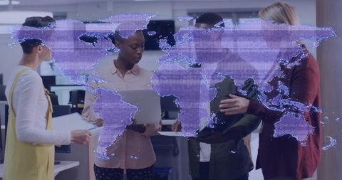 Collaborating team discussing global strategy over laptop with holographic world map overlay