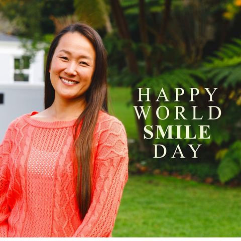 Asian woman smiling for world smile day celebration in garden