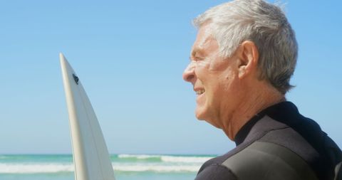 Senior Man with Surfboard Enjoying Beach View - Download Free Stock Images Pikwizard.com