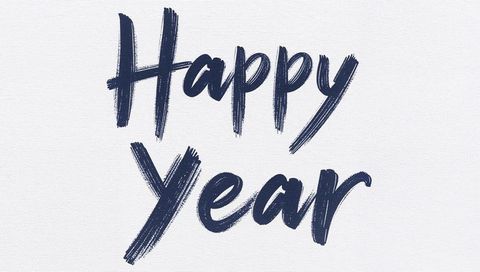 Hand-brushed navy blue happy year lettering on white canvas with bold brushstroke texture