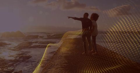 Couple enjoying scenic ocean view with digital wave overlay