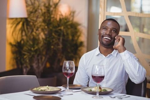 Man Enjoying Conversation on Phone During Restaurant Meal - Download Free Stock Images Pikwizard.com