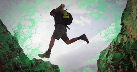 Man Leaping Across Rugged Canyon in Outdoor Adventure