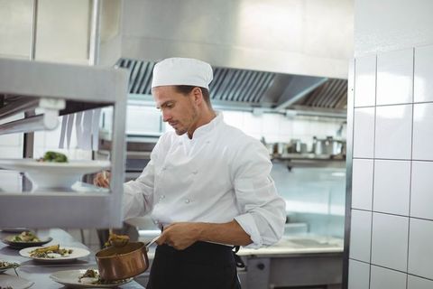 Professional Chef Preparing Gourmet Dish in Restaurant Kitchen