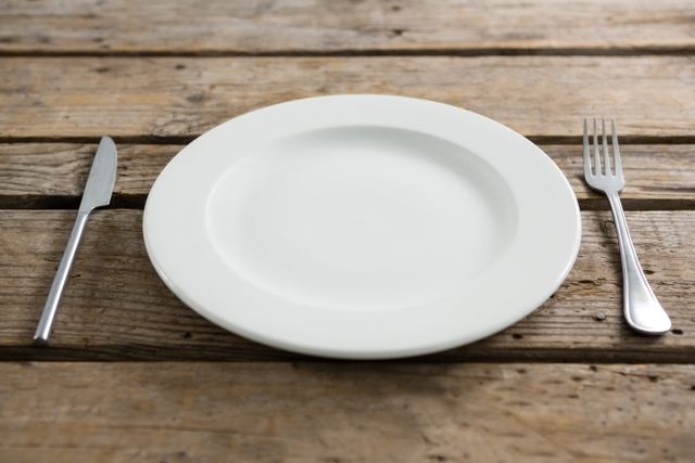 Empty Plate with Cutlery on Rustic Wooden Table - Download Free Stock Photos Pikwizard.com