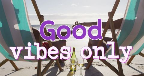 Couple Relaxing on Sunny Beach with 'Good Vibes Only' Message