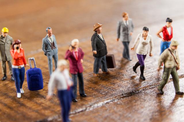 Conceptual image of miniature people travelling