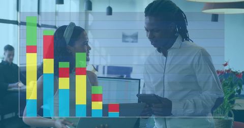 Colleagues discussing work with data graph overlay in modern office