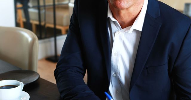 Businessman Working Over Coffee at Office - Download Free Stock Images Pikwizard.com