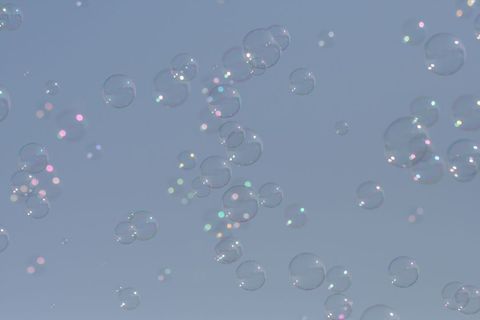 Colorful Soap Bubbles Floating in Clear Blue Sky