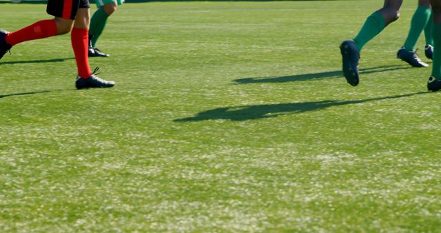 Football Players Running on Sunny Field During Match - Download Free Stock Images Pikwizard.com