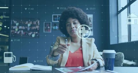 Businesswoman pointing at augmented reality interface with digital icons and documents