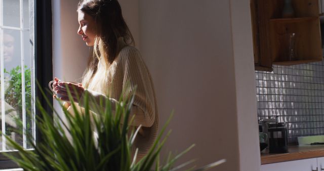 Woman Enjoying Morning Coffee by Window in Cozy Home Environment - Download Free Stock Images Pikwizard.com