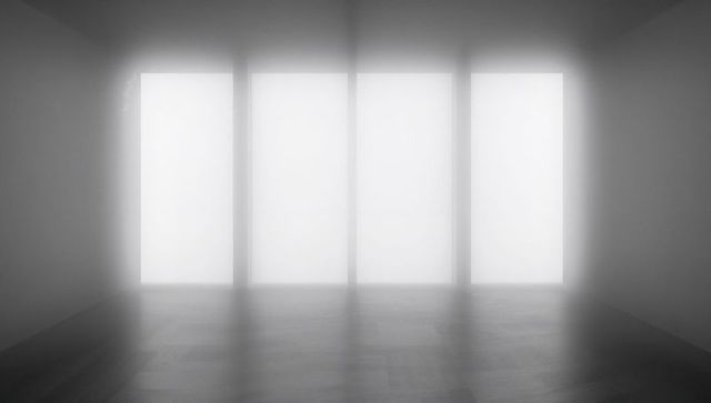 Minimalist studio with four frosted vertical windows casting soft light on wooden floor