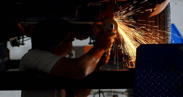 Auto Mechanic Grinding Vehicle Underbody with Sparks Flying - Download Free Stock Images Pikwizard.com