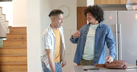 Diverse Male Friends Laughing Together at Kitchen Island