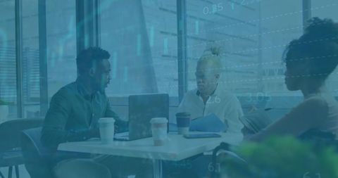 Diverse team discussing financial data in modern office space