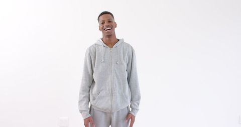 Smiling Young Man in Gray Hoodie Expressing Confidence - Download Free Stock Images Pikwizard.com