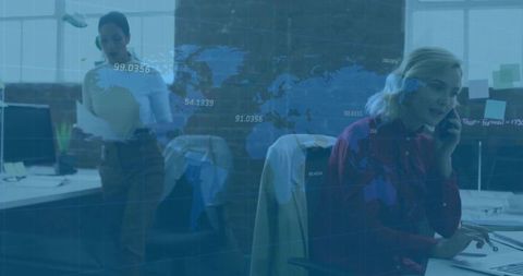 Businesswomen Collaborating in Modern Office with Digital Graphics