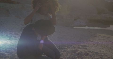 Romantic evening on beach with couple embracing and phone