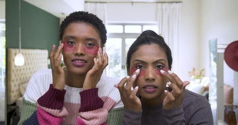 Diverse friends enjoy skincare with bright under-eye patches