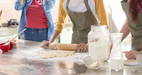 Group of Friends Baking Together in Home Kitchen