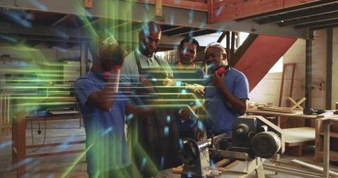 Inspecting turned wood block beside lathe, team crafting rustic wooden bowl together